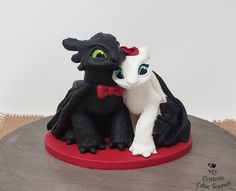 there is a cake that looks like a dragon and a cat