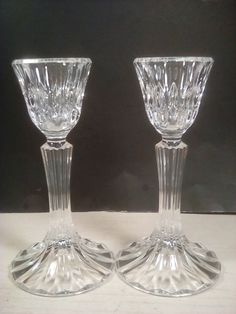 two clear glass vases sitting next to each other