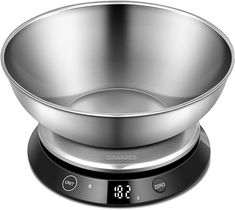 a stainless steel bowl sitting on top of a digital scale with an alarm clock in front of it