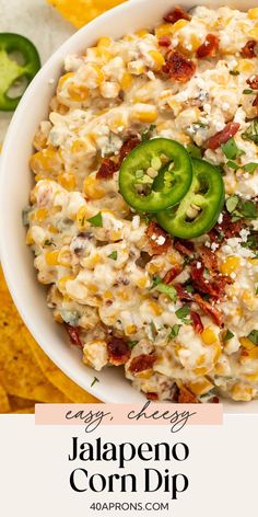 a white bowl filled with mexican food next to tortilla chips and jalapeno