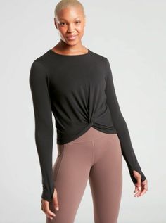 NWT Athleta Essence Twist Top in Black Size S Small #579671 NEW WITH TAGS Retail $59 FIT & SIZING Fitted next to the body Body length in size medium: 20" front, 22" back PRODUCT DETAILS FOR: Yoga, studio, or floor practice FEEL: Soft and comfy workout wear FAVE: Front twist adds an interesting detail #579671 FABRIC + CARE Recycled Polyester/TENCEL™ Modal/Spandex SUSTAINABLE: Made from Recycled Poly, a material sourced from post-consumer plastic bottles that helps lessen our impact on the world W Twist Top, Confident Woman, Yoga Tops, Athletic Fashion, Performance Outfit, Yoga Studio, Yoga Wear, Yoga Clothes, Workout Wear