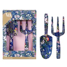 a set of utensils and fork in a box with floral designs on it