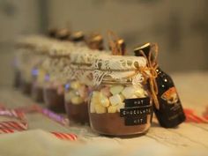 several jars filled with hot chocolate and marshmallows