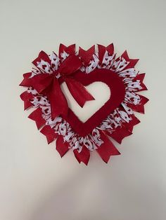 a heart shaped decoration made out of red and white paper