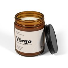 a jar of virgo candle sitting next to a black lid