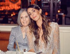 two women sitting next to each other at a table