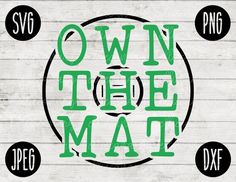 the words own the mat are in green and black on a white wood plank background