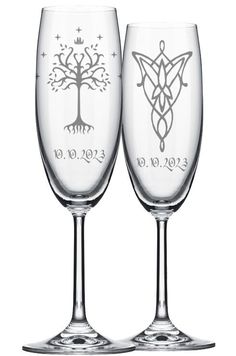 two wine glasses that are next to each other on a white background, one has a tree and the other has an ornament