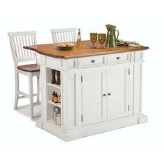 a white kitchen island with two chairs and a wooden counter top in front of it