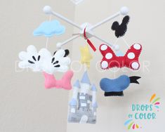 some kind of mobile that is hanging from the ceiling with mickey mouse and minnie mouse on it