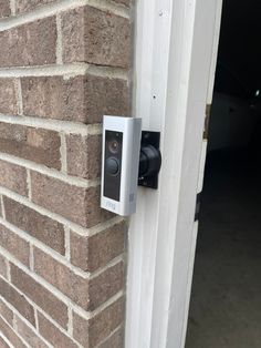 an electronic door lock on the side of a brick building