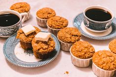 several muffins and cups of coffee on a table