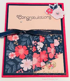 congratulations card with pink and blue flowers on the front, red ribbon around the edges