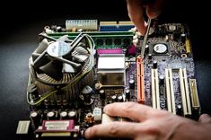 a person is working on a computer motherboard