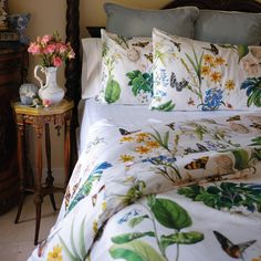 a bed with flowers and butterflies on it