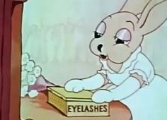 an animated image of a rabbit opening a box with the words eyelashes on it