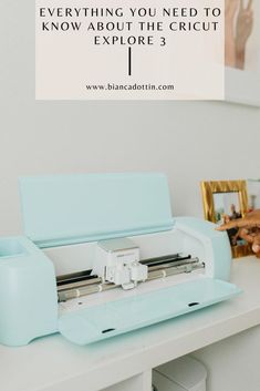 a blue machine sitting on top of a white table next to pictures and framed photos