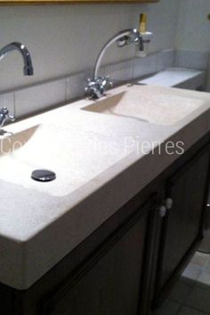 two white sinks in a bathroom under a mirror with faucets on the side