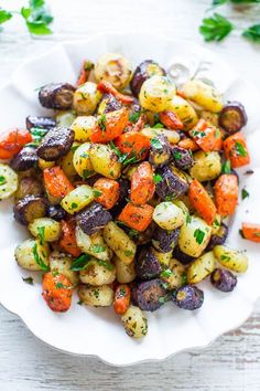 a white plate topped with carrots and potatoes