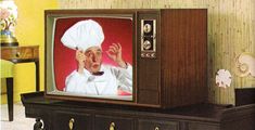 an old tv with a chef on it's face and hands in the air