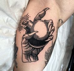 a black and white tattoo on the arm of a man with a turtle holding an apple