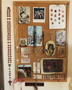 a bulletin board with many items on it and a cross hanging from the wall next to it