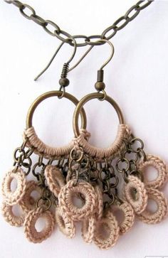 a pair of earrings is hanging from a chain