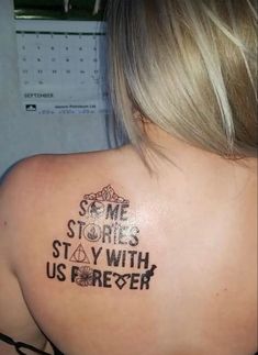 the back of a woman's shoulder with some writing on it