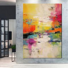 an abstract painting hangs on the wall