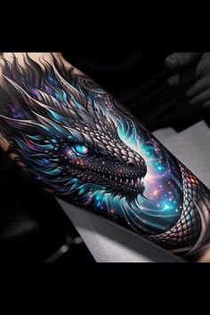 a man's arm with an intricate dragon tattoo on the left side of his arm