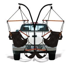 two hammock chairs attached to the back of a white truck with black straps