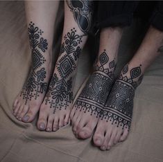 two people with tattoos on their feet