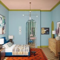 a bedroom with blue walls and orange rugs on the floor next to a bed