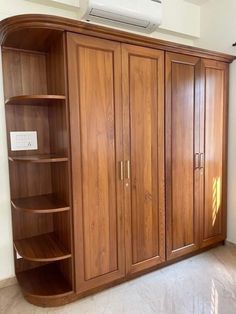 an empty room with wooden cabinets and a air conditioner