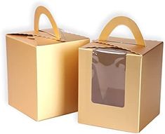 two brown boxes with handles are sitting side by side