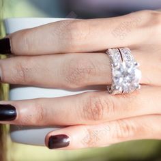 a woman's hand with two rings on it