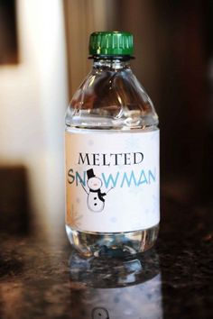 a bottle of water sitting on top of a counter next to a glass container with a snowman label