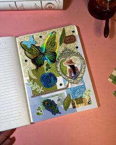 an open notebook with stickers on it and a person's hand next to it