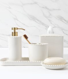 white bathroom accessories set with soap dispenser and toothbrush holder