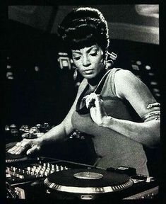 the woman is mixing music on her turntable