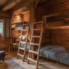 there is a bunk bed in the room with two ladders on the wall next to it