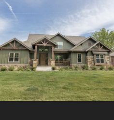 a large house sitting in the middle of a lush green field on a sunny day