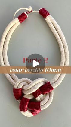 a white and red rope necklace on a table