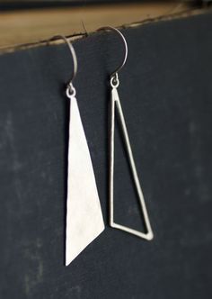 Asymmetrical, unique, but a fun pair of earrings to dress up or dress down. One earring, I formed from sterling wire. The other earring, I cut and Geometric Silver Earrings, Silver Triangle Minimalist Earrings, Unique Triangle Sterling Silver Jewelry, Silver Triangle Metal Jewelry, Modern Silver Triangle Earrings, Simple Silver Earrings, Modern Silver Jewelry, Gold Bar Earrings, Blue Crystal Earrings