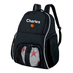 a black backpack with white and red soccer balls on the front, which reads charles