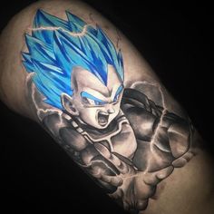 a man's arm with a blue and white dragon tattoo on it, in the dark