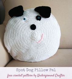 a crocheted white dog pillow sitting on top of a couch