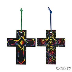 two cross shaped ornaments hanging from strings