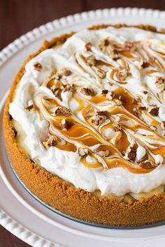 a cheesecake topped with whipped cream and caramel drizzle