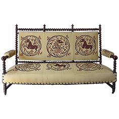 an old fashioned couch with decorative designs on it